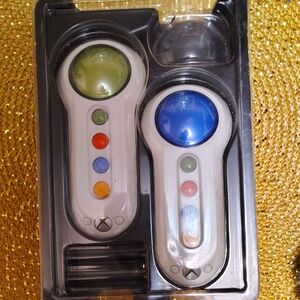 White and Green Controllers for Video Games with Unique Illumination.